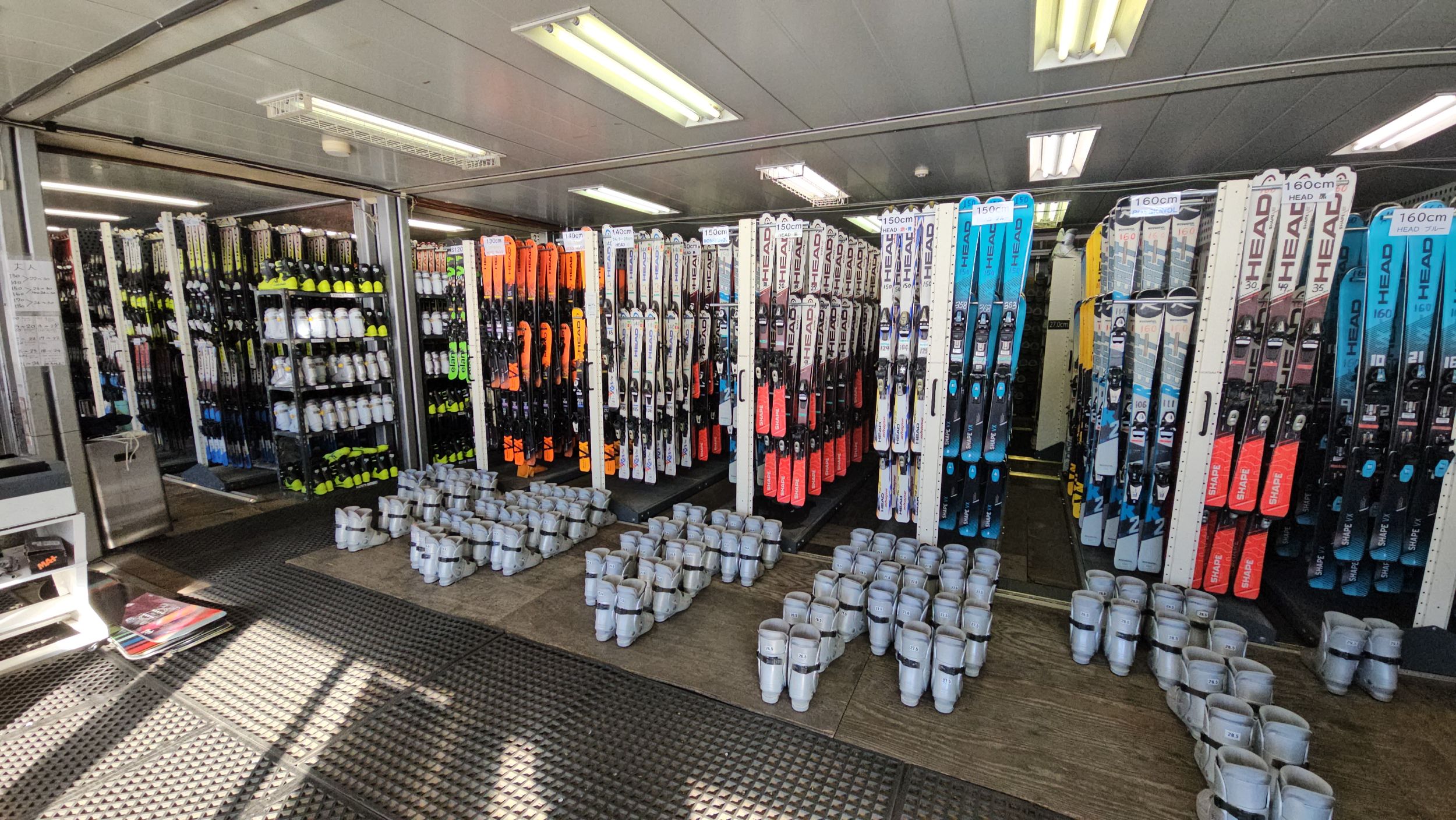Rental skis and snowboards on racks at Fujiten Snow Resort