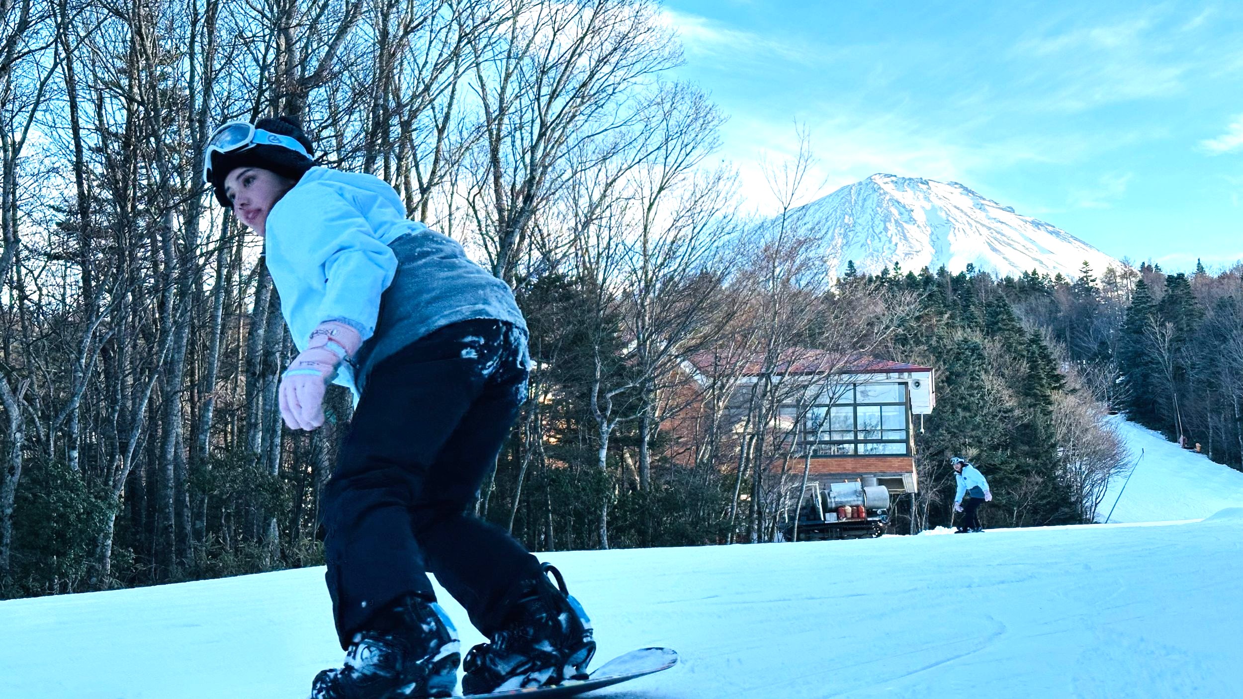 Skiing down a slope facing Mt. Fuji