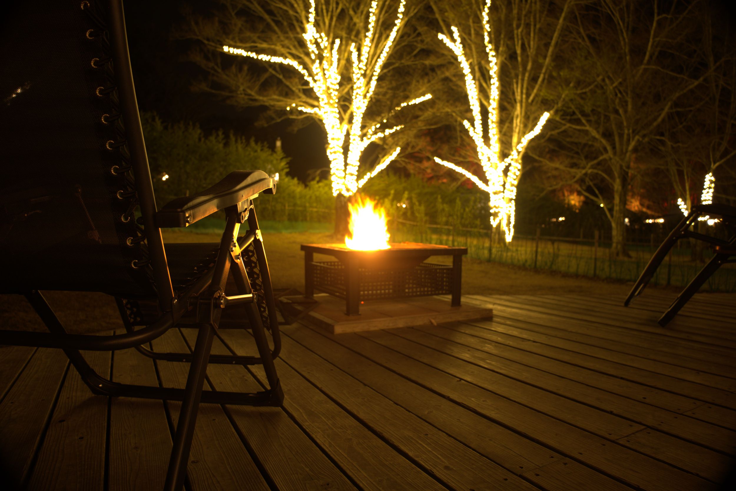 A campfire burning on the grounds at night